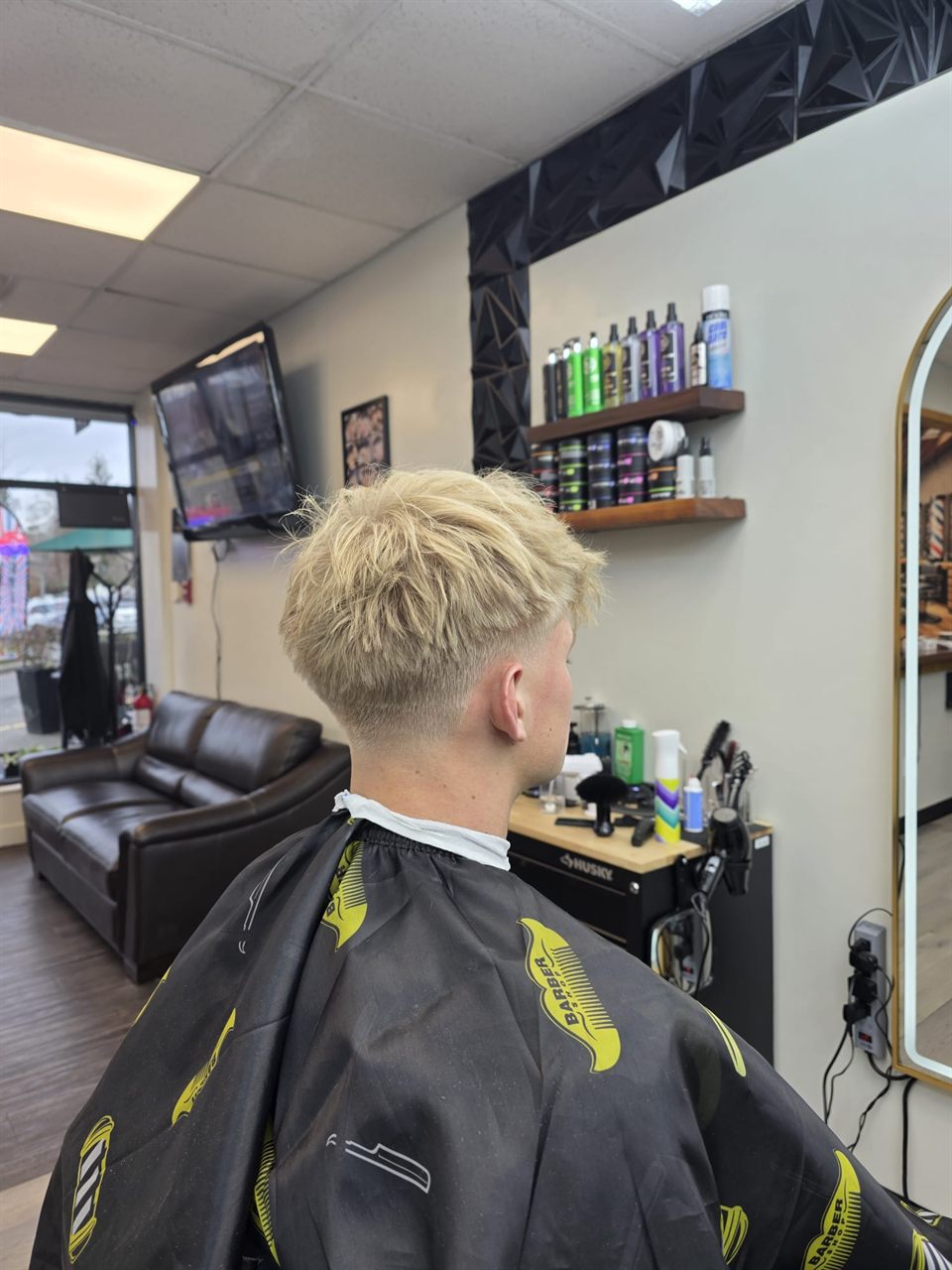 Side view of a low skin fade at a barbershop in Broadmead Village, Saanich